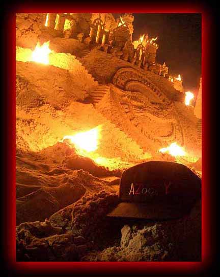Sand castle on the beach on fire
